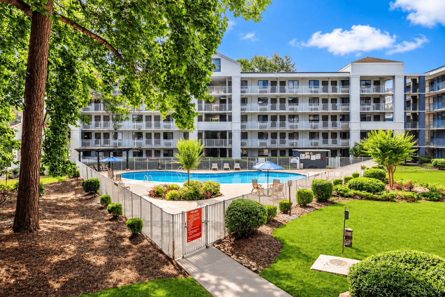 A large building with a pool in front of it.